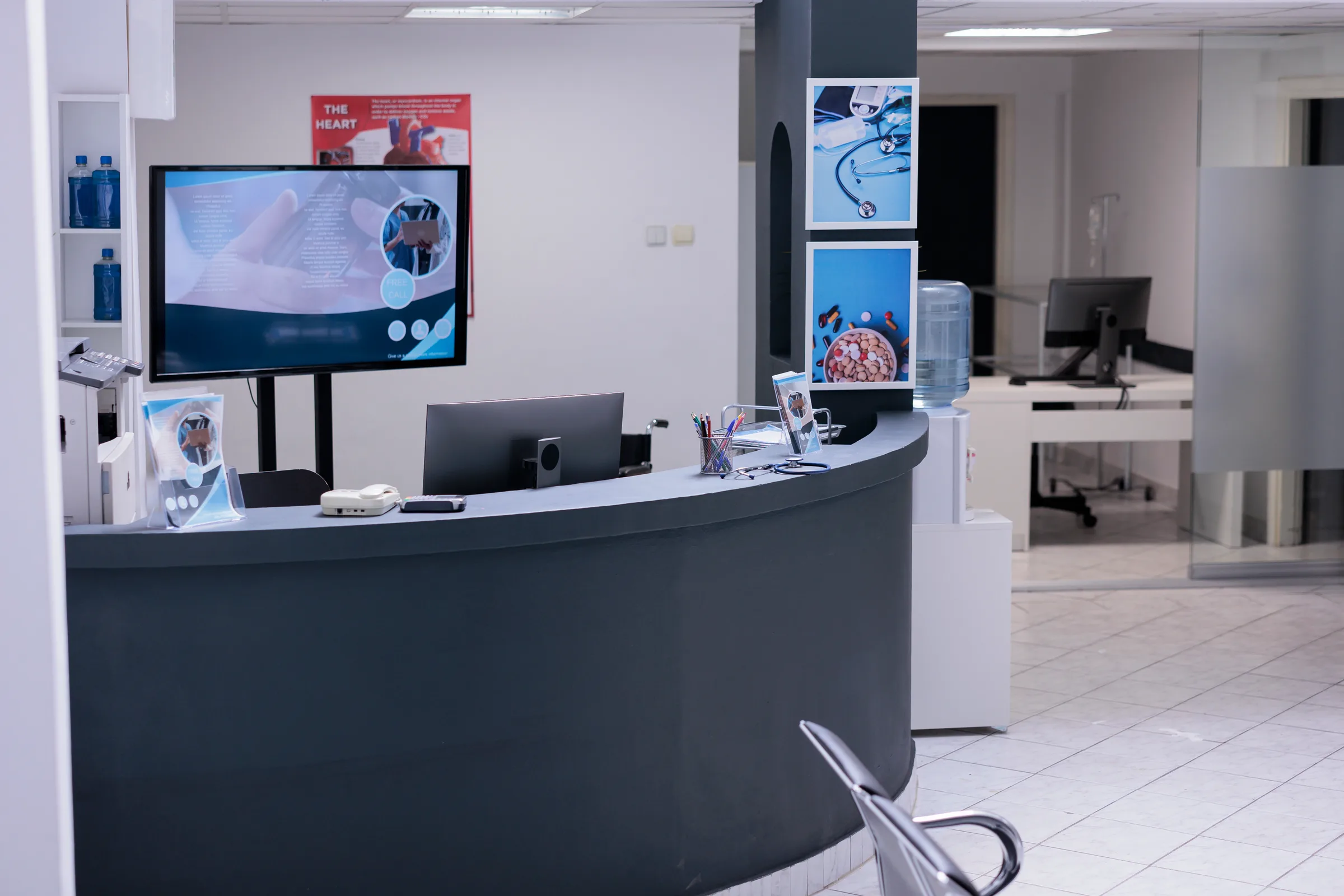 Quiet healthcare lobby with reception desk and waiting seats