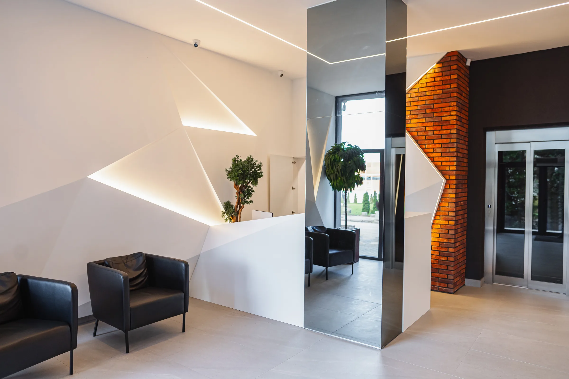 Modern reception area with warm wood, seating, and soft lighting